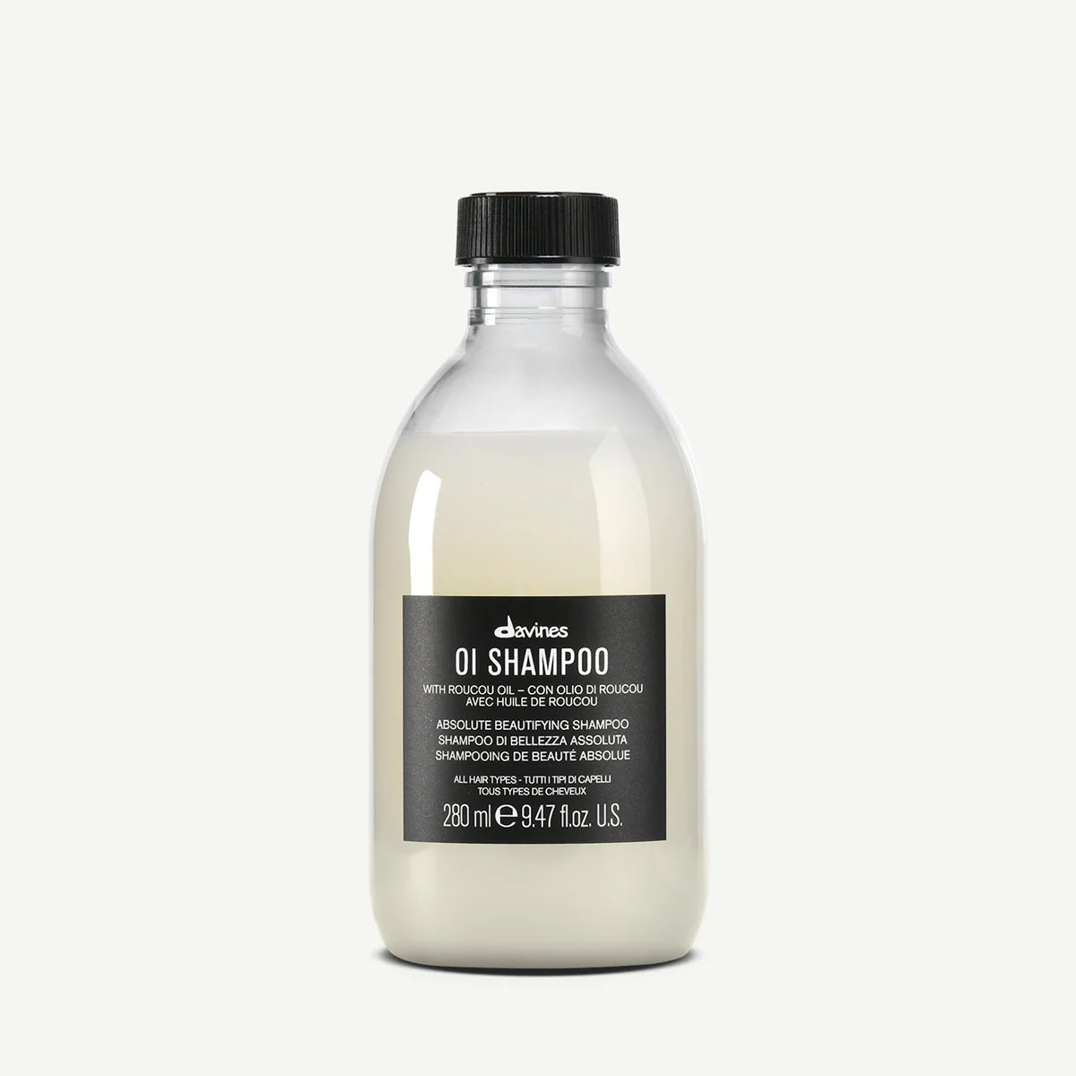 Bottle of Davines OI Shampoo with roucou oil for all hair types on a white background