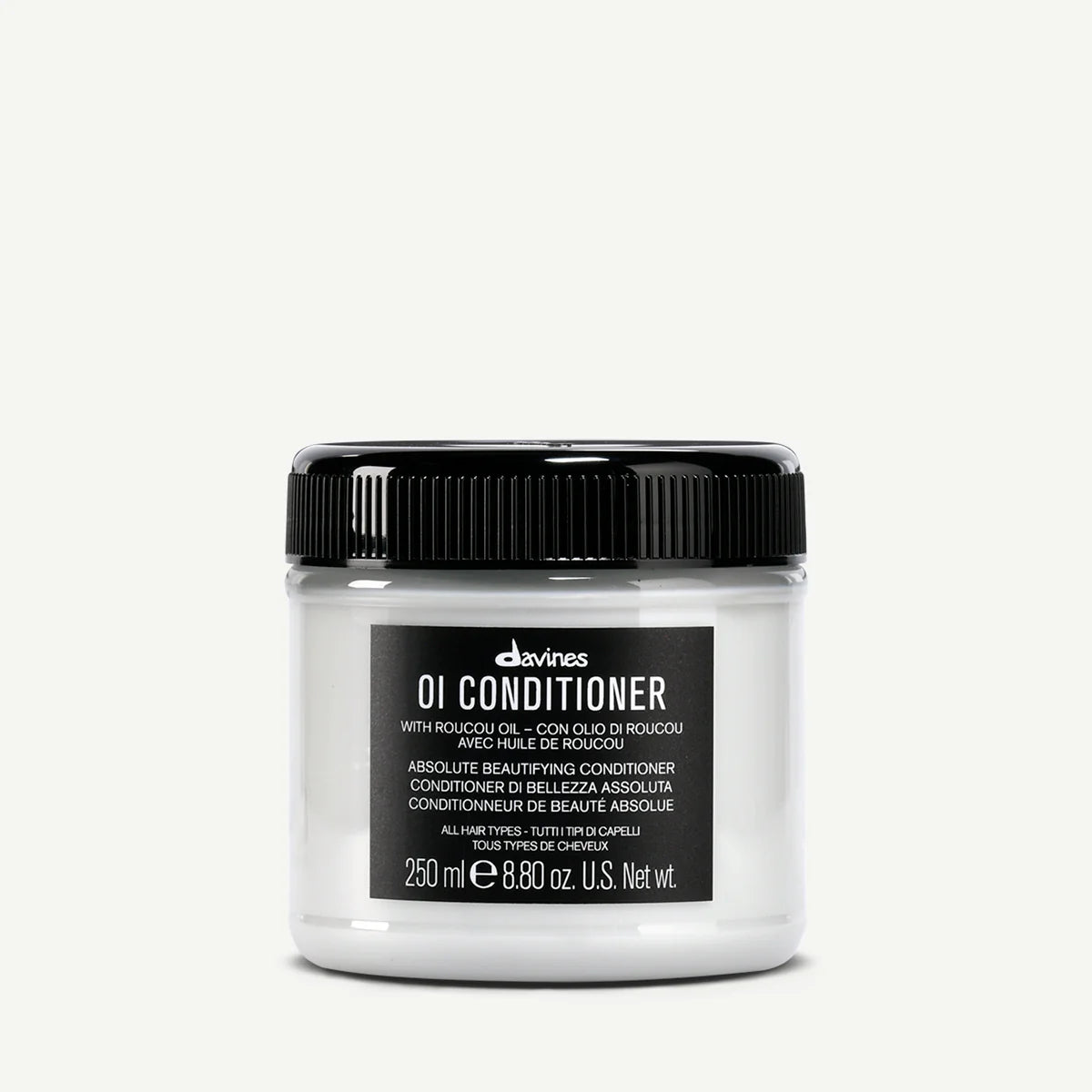 Davines OI Conditioner jar with roucou oil for all hair types on a white background