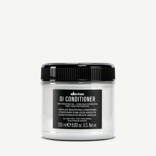 Davines OI Conditioner jar with roucou oil for all hair types on a white background
