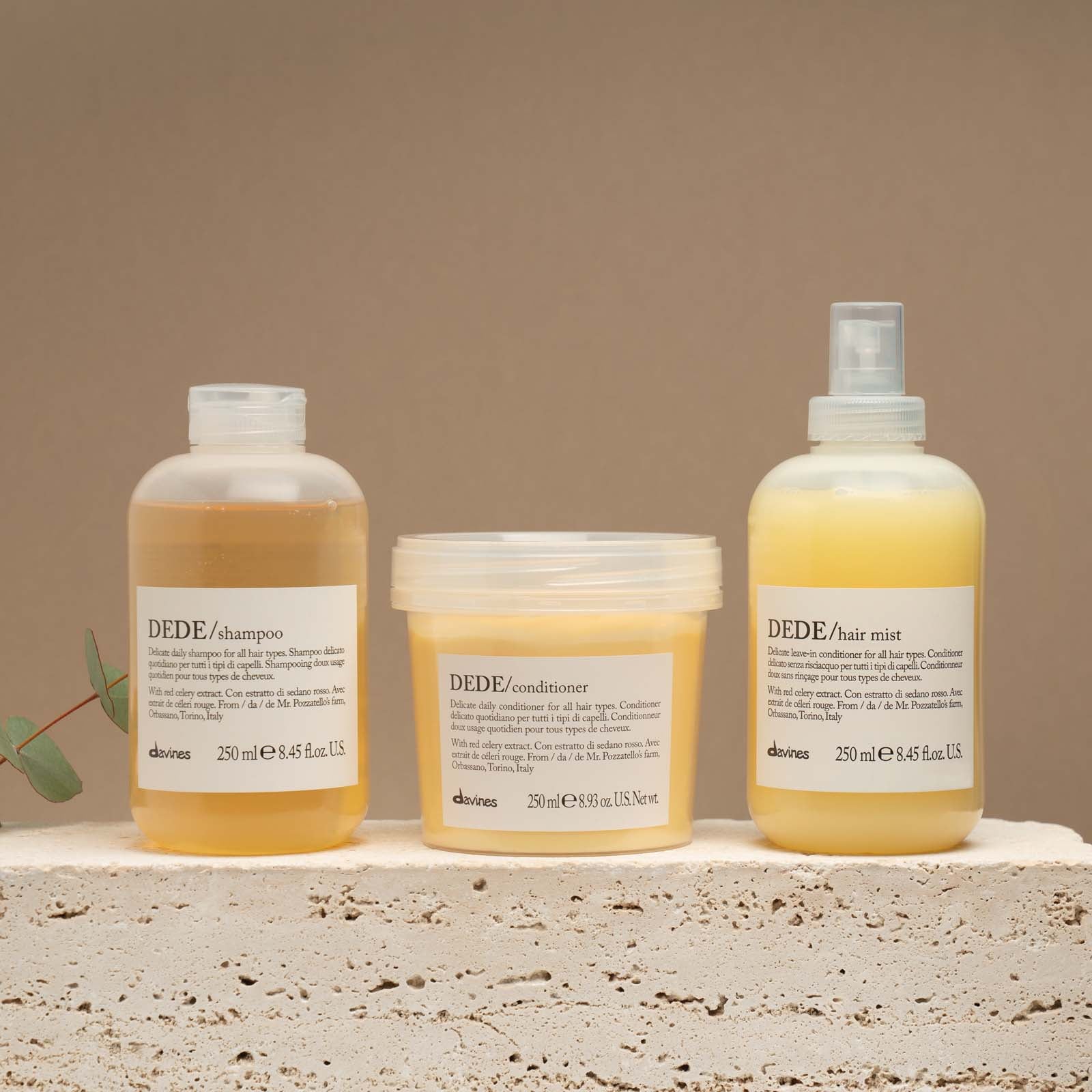 Three Davines DEDE delicate hair care products including shampoo, conditioner, and hair mist for all hair type