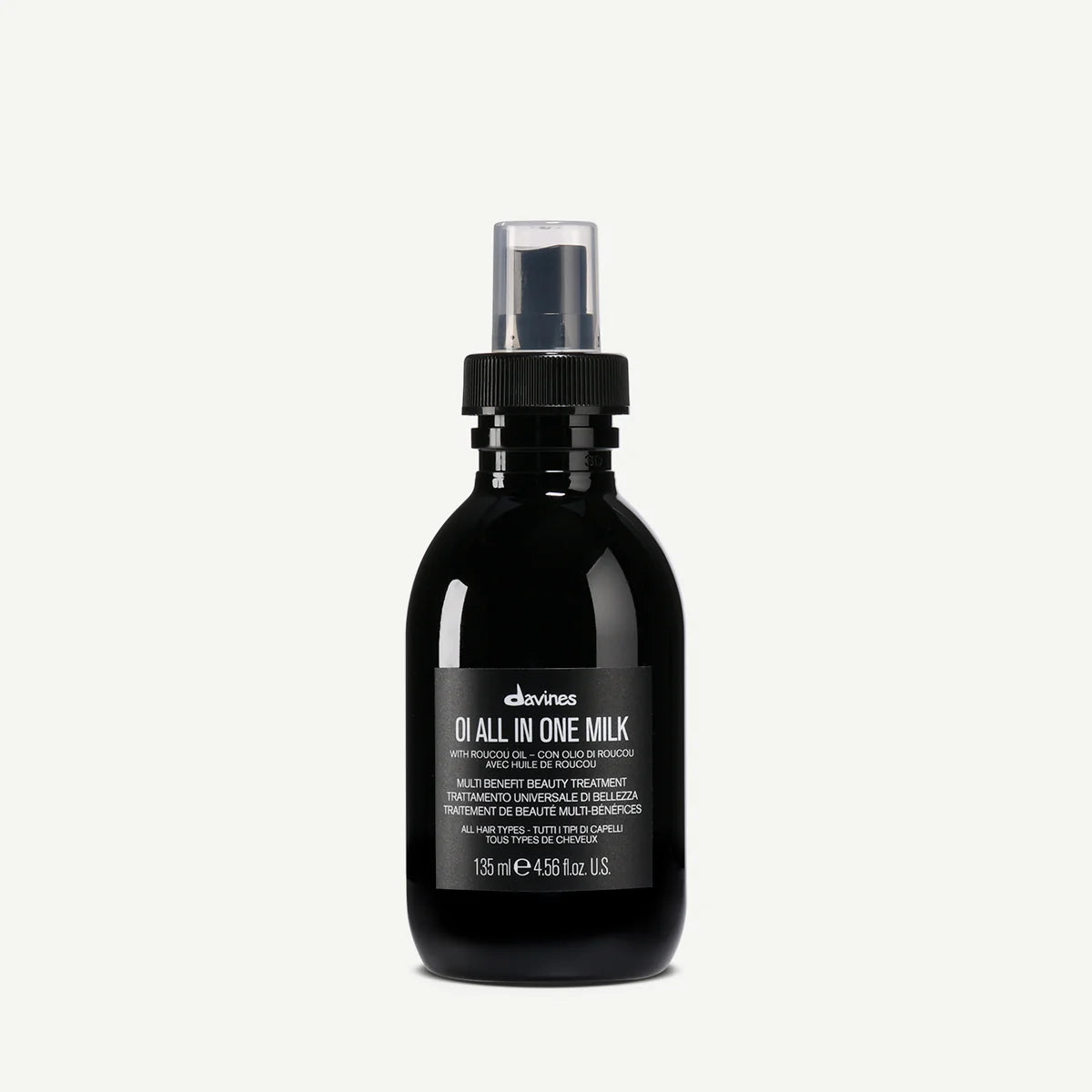 Black bottle of Davines hair milk with roucou oil for all hair types