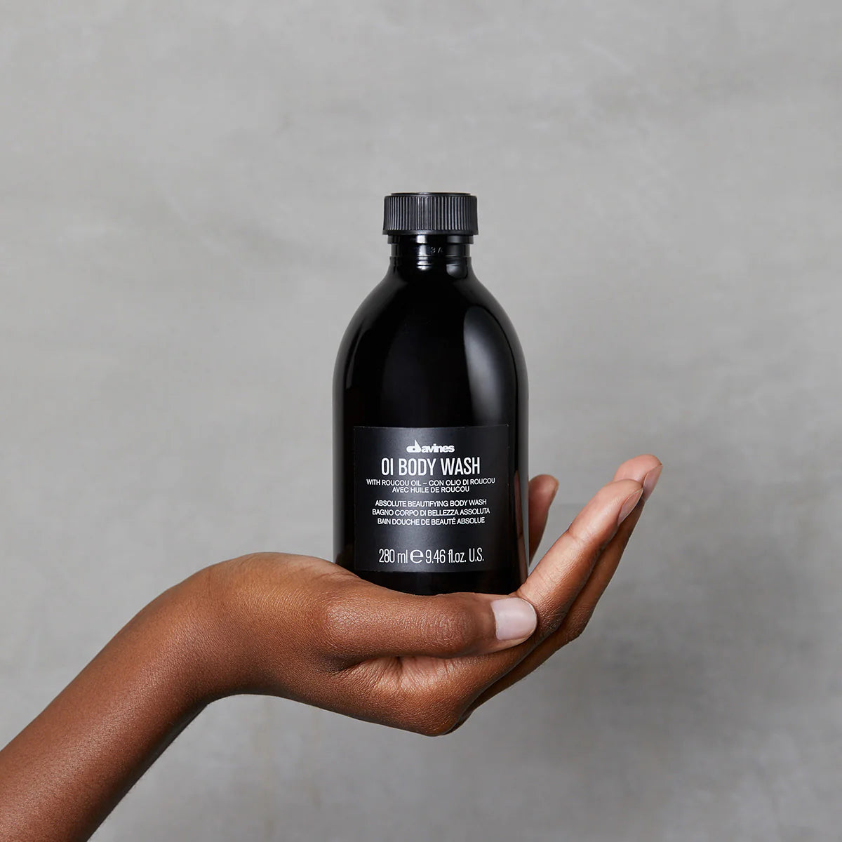 Black bottle of OI Body Wash with roucou oil for absolute beautifying