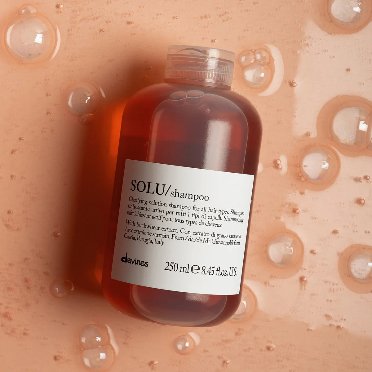 Bottle of davines SOLU clarifying shampoo for all hair types